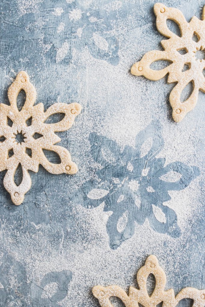 Cardamom Vanilla Bean Sugar Cookies cut with a gian snowflacke cutter and dusted with powdered sugar.