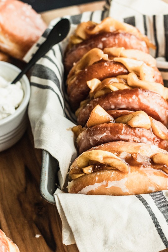 Soft yeast donuts stuffed with spiced apple filling make these Apple Pie Donuts the ultimate fall treat! Serve with whipped cream and an extra dusting of cinnamon. || Good Things Baking Co. #goodthingsbaking #donuts #applepie #fallbaking #doughnuts