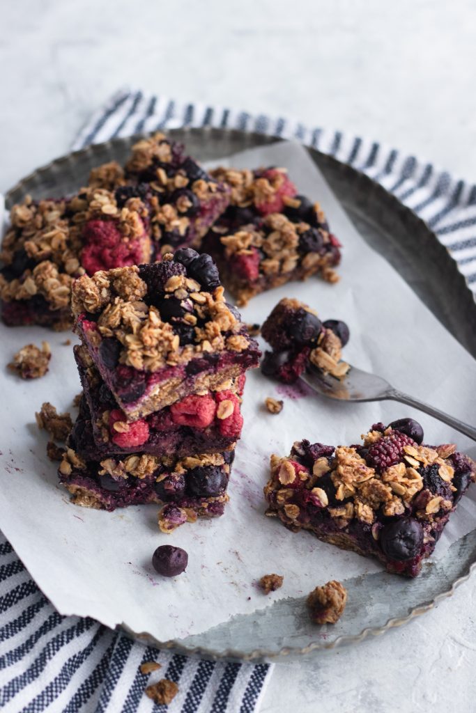 A stack of Berry Breakfast Bars with an oat crumble topping.