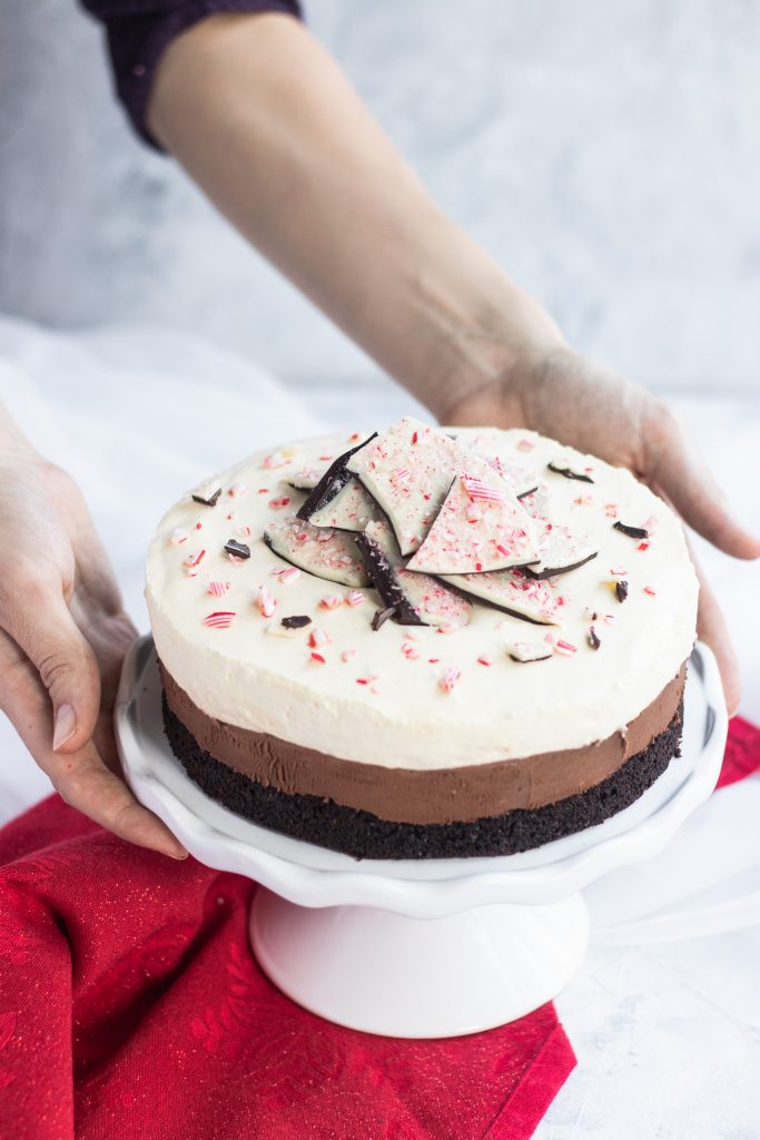 Peppermint Chocolate Mouse Cake -- a dark chocolate sponge topped with a layer of chocolate mousse, then a layer of peppermint mousse, all garnished with chocolate peppermint bark