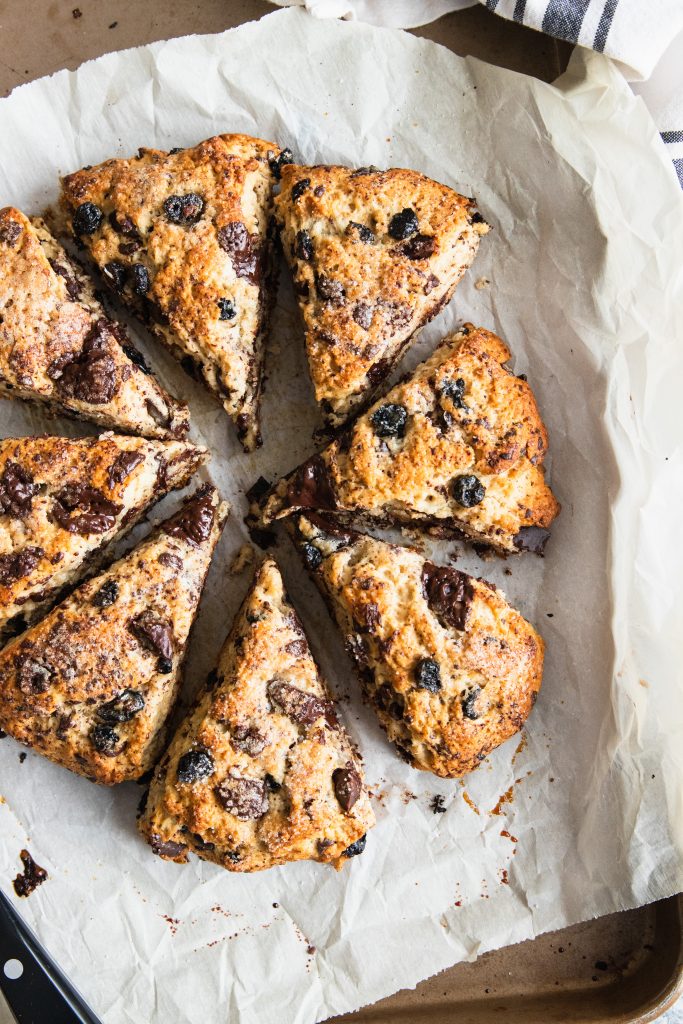 A round of Blueberry Chocolate scones cut into wedges, then sprinkled with sugar and baked for a crispy outside and soft, tender inside.