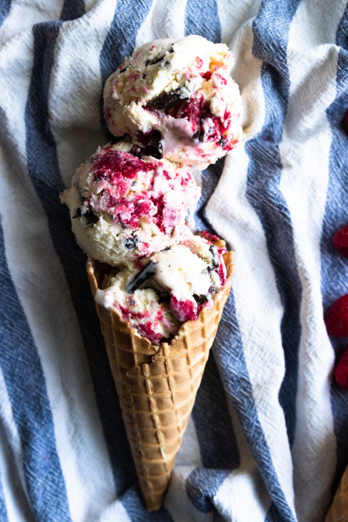 Three scoops of chocolate and raspberry swirl ice cream in a cone