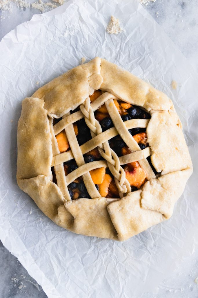 An uncooked Blueberry Peach Galette
