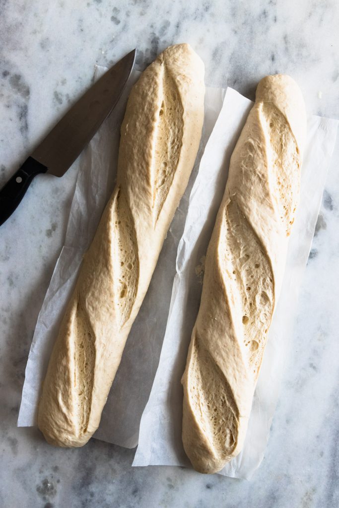 Risen French baguettes, slashed to allow for optimal rising and ready to bake
