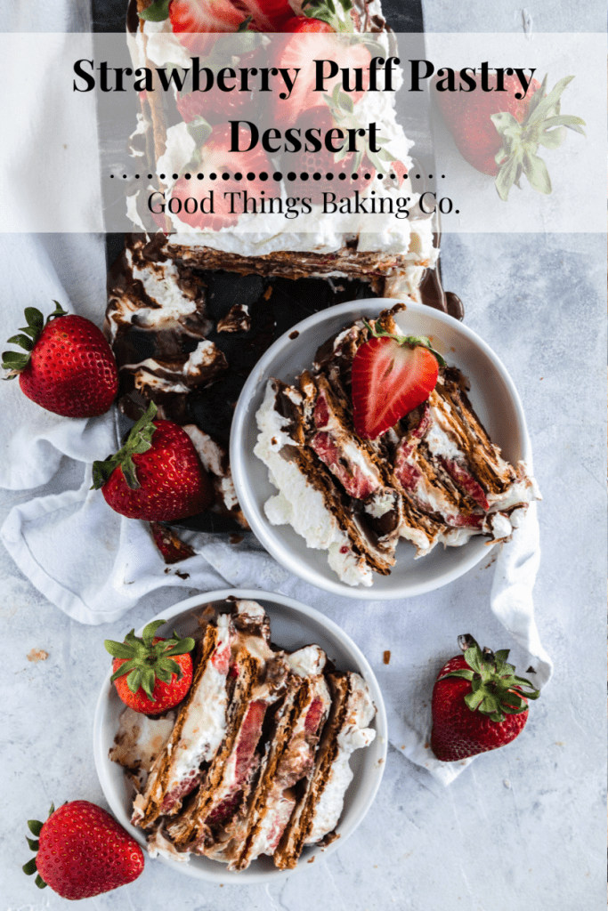 A strawberry napoleon dessert with layers of puff pastry, pastry cream, whipping cream, fresh strawberries, and chocolate ganache.