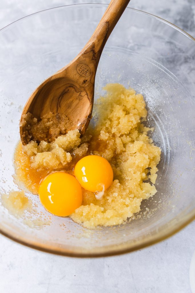 Add egg yolks to the butter and sugar creamed together.