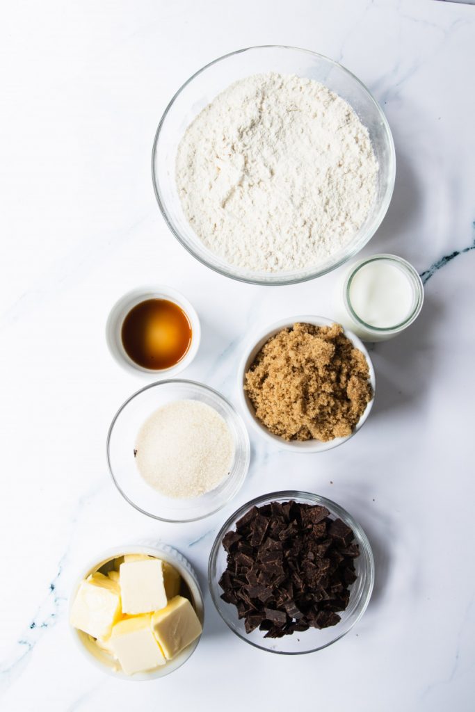 The ingredients for edible cookie dough--heat treated flour, baking soda and salt, brown and white sugar, milk, butter, vanilla extract, and chopped chocolate.