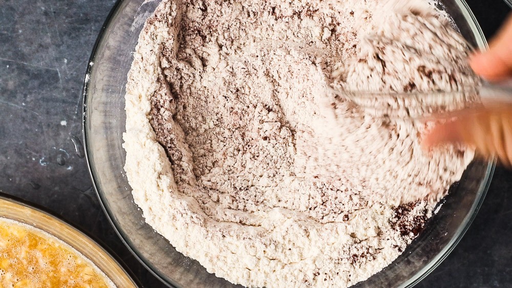 Whisking together the all-purpose flour, baking soda, salt, and cocoa powder.