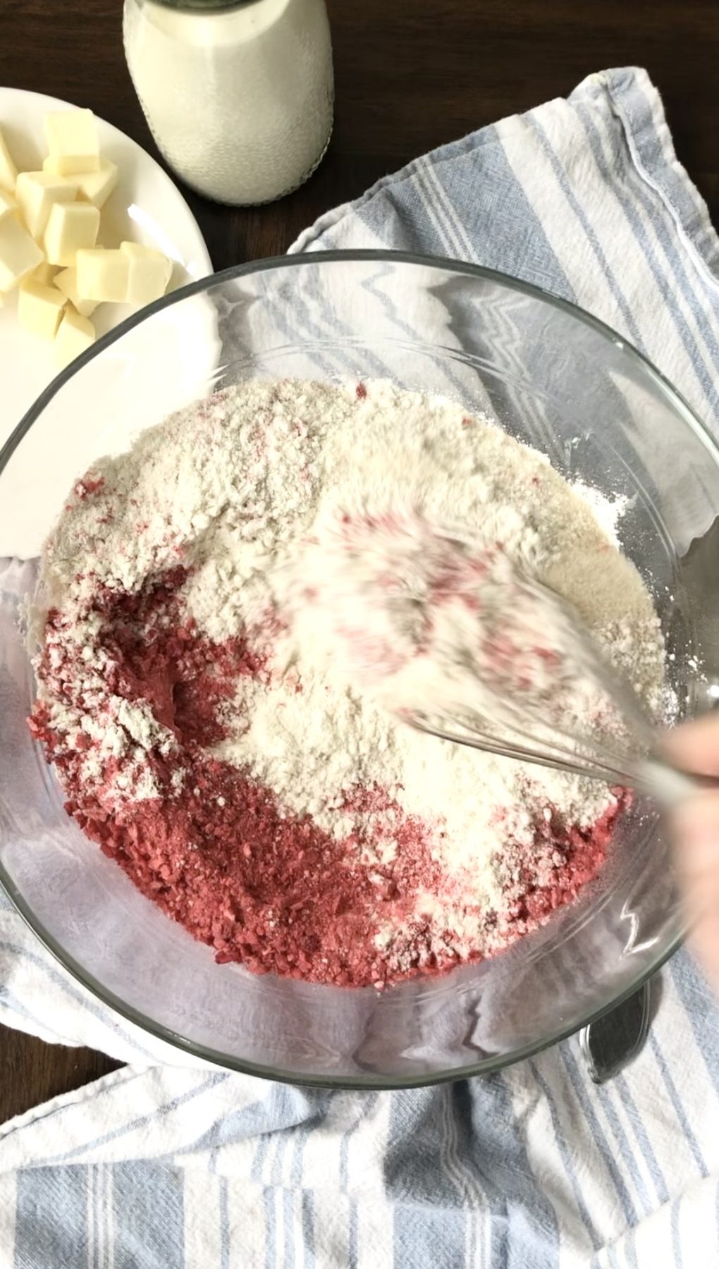 Whisking together the dry ingredients--flour, sugar, crushed freeze-dried strawberries, and baking powder and soda.