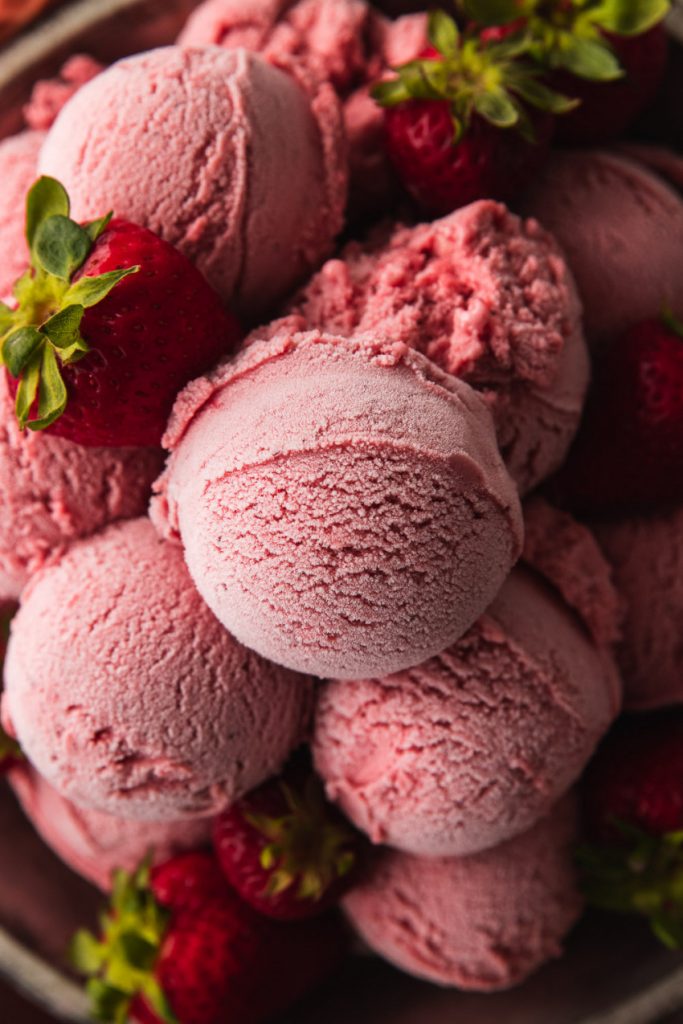 Scoops of pink, smooth, and creamy strawberry ice cream.