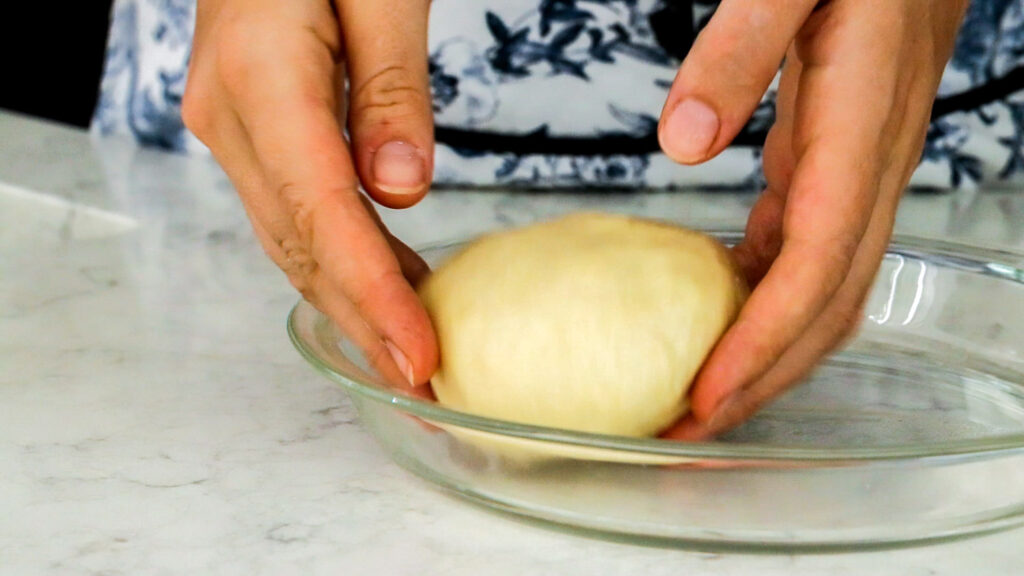 Place the shaped balls of dough on a plate to rise.