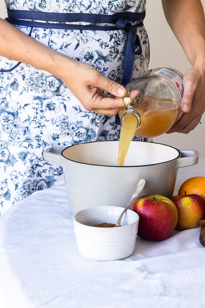 Pouring the cider into a pot.