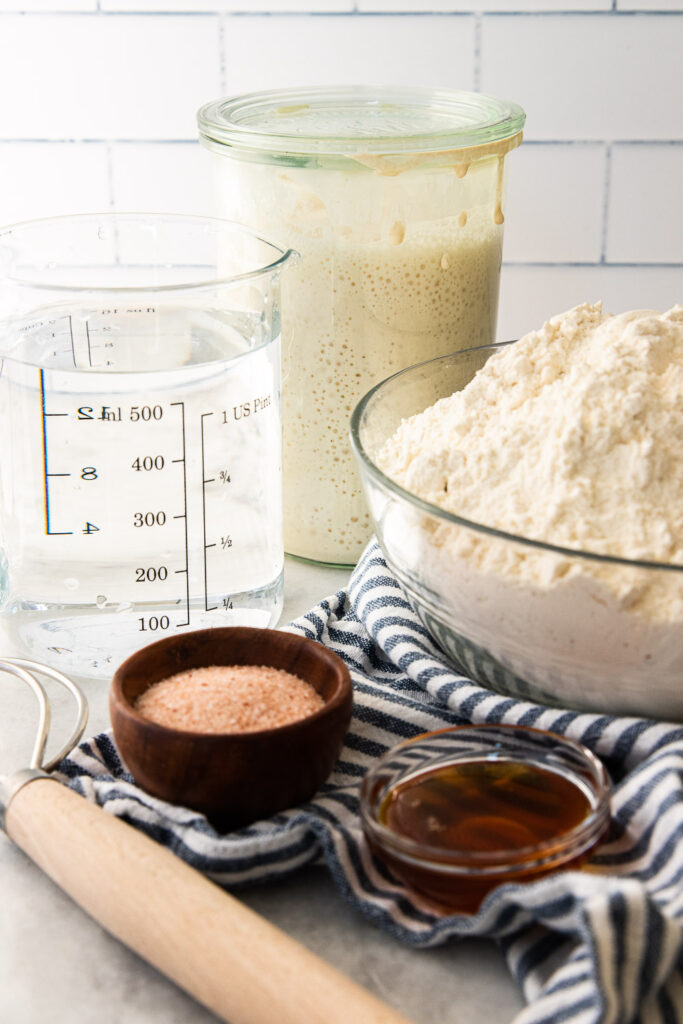The ingredients needed for sourdough bread bowls-- flour, water, active starter, honey, and salt.