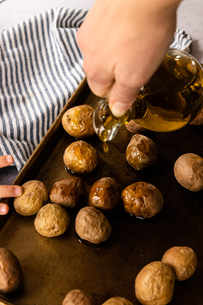 Drizzle a generous amount of olive oil over the potatoes.