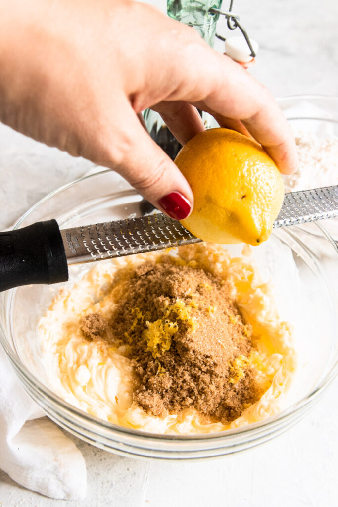 Zesting the lemon into the brown sugar before rubbing it in.