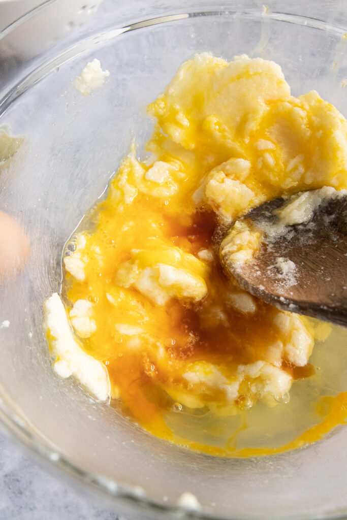 Add the eggs and vanilla extract to the creamed butter and sugar.