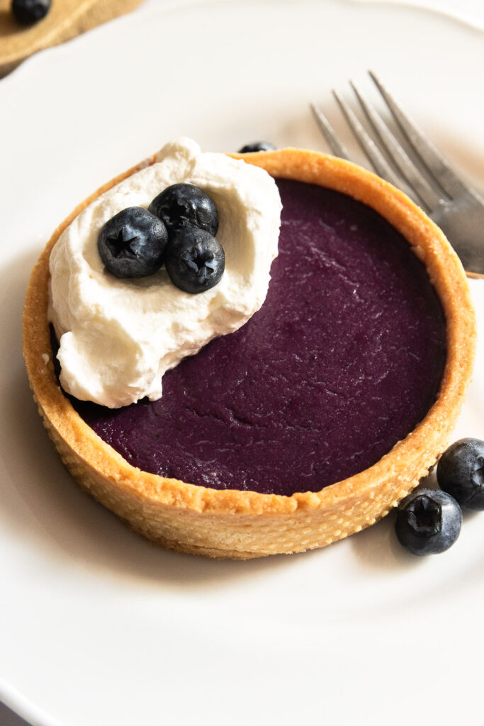 A tart crust filled with blueberry curd.