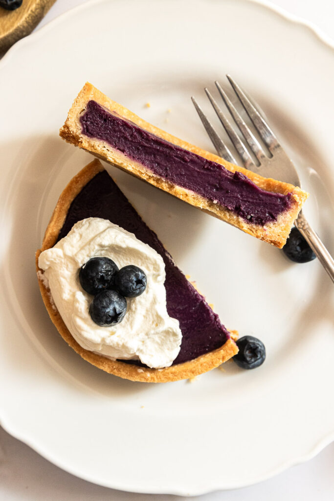 Blueberry curd tart, cut open with the filling set.