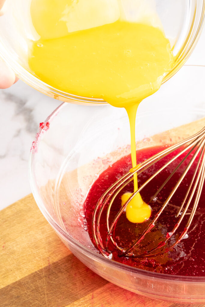 Slowly add the egg yolk to the cranberries mixture while whisking.