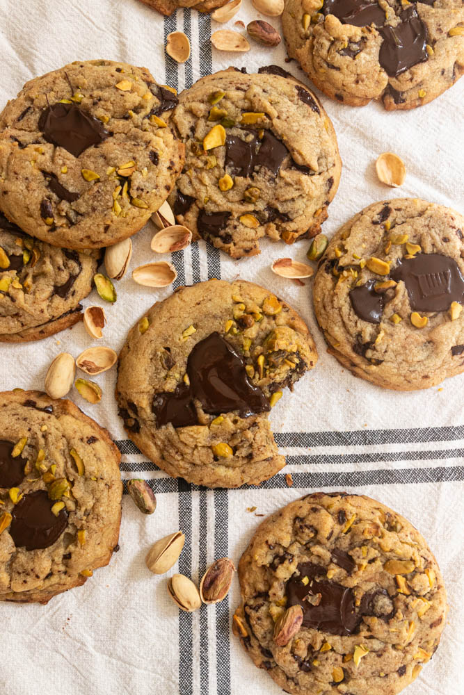 Several chocolate pistachio and chocolate chip cookies arranged in a flat aly.