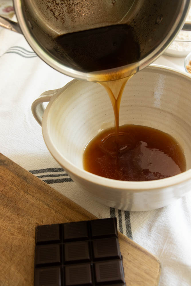 Browned butter pouring into a mixing bowl.