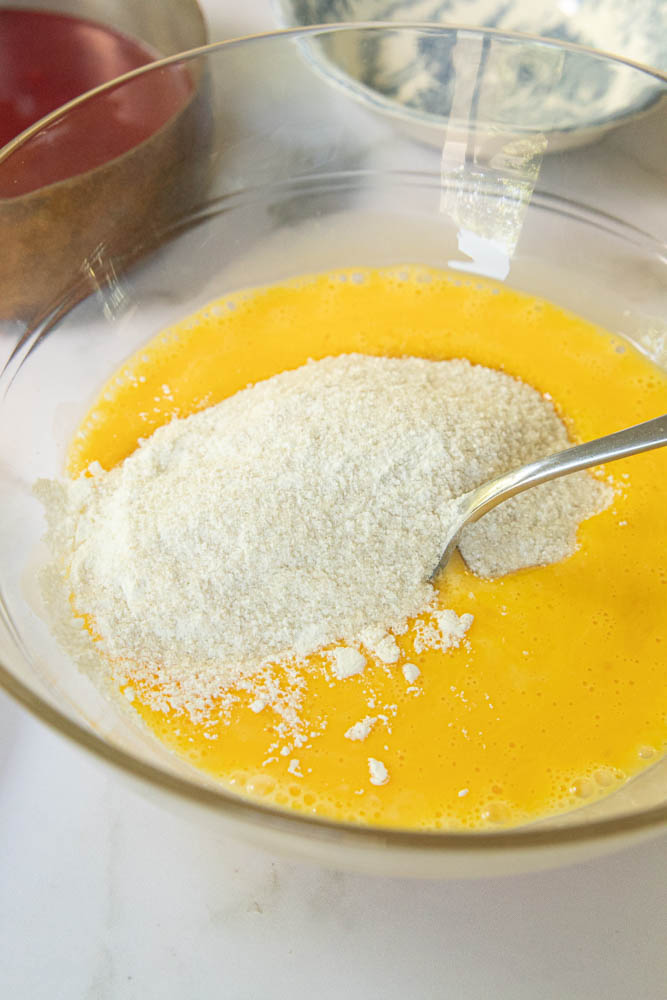 Adding the sugar and cornstarch to the egg yolks and milk.