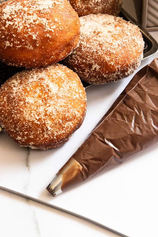 The donut cream filling in a piping bag, ready to fill the donuts.