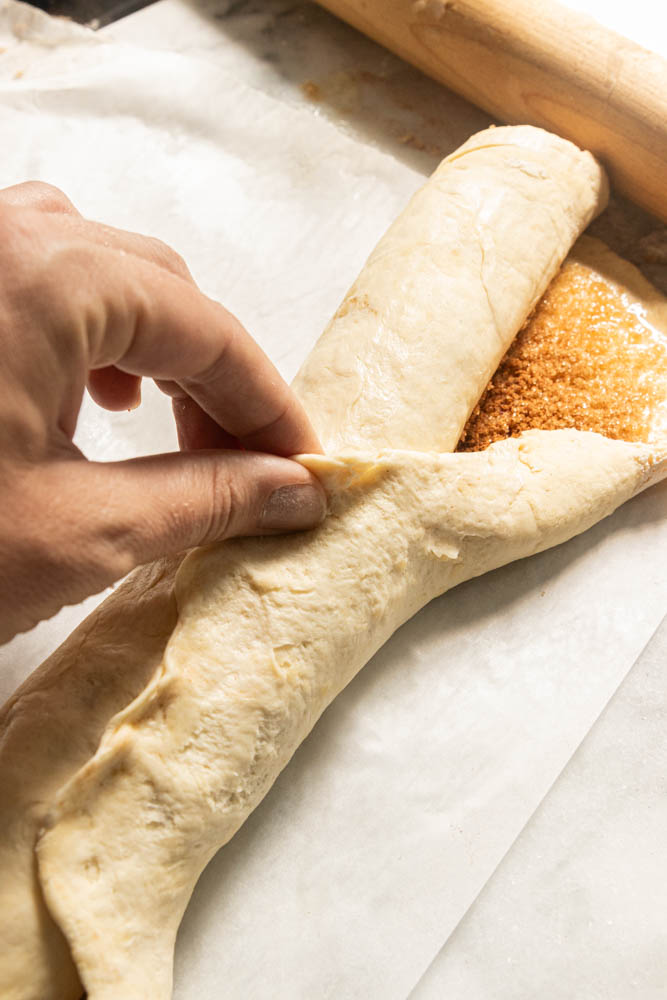 Pinching the dough closed.