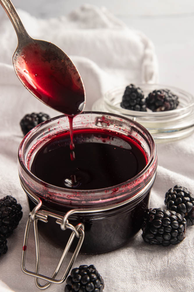 The finished coulis pouring off a spoon.