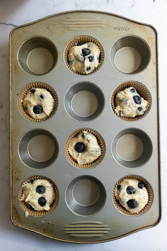 Muffin tins filled with batter and ready to bake.