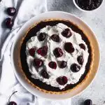 Chocolate Cherry Tart -- A delicate pastry case filled with a layer of sweet cherries and topped with chocolate ganache. Pile it high with whipped cream and top with more cherries.