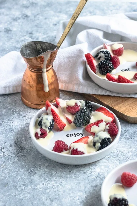 Crème Anglaise poured over berries