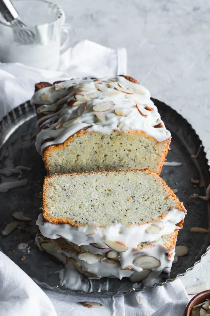Slices of Glazed Almond Poppy Seed Bread topped with sliced almonds