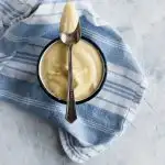 Creamy, thick, classic pastry cream on a spoon.