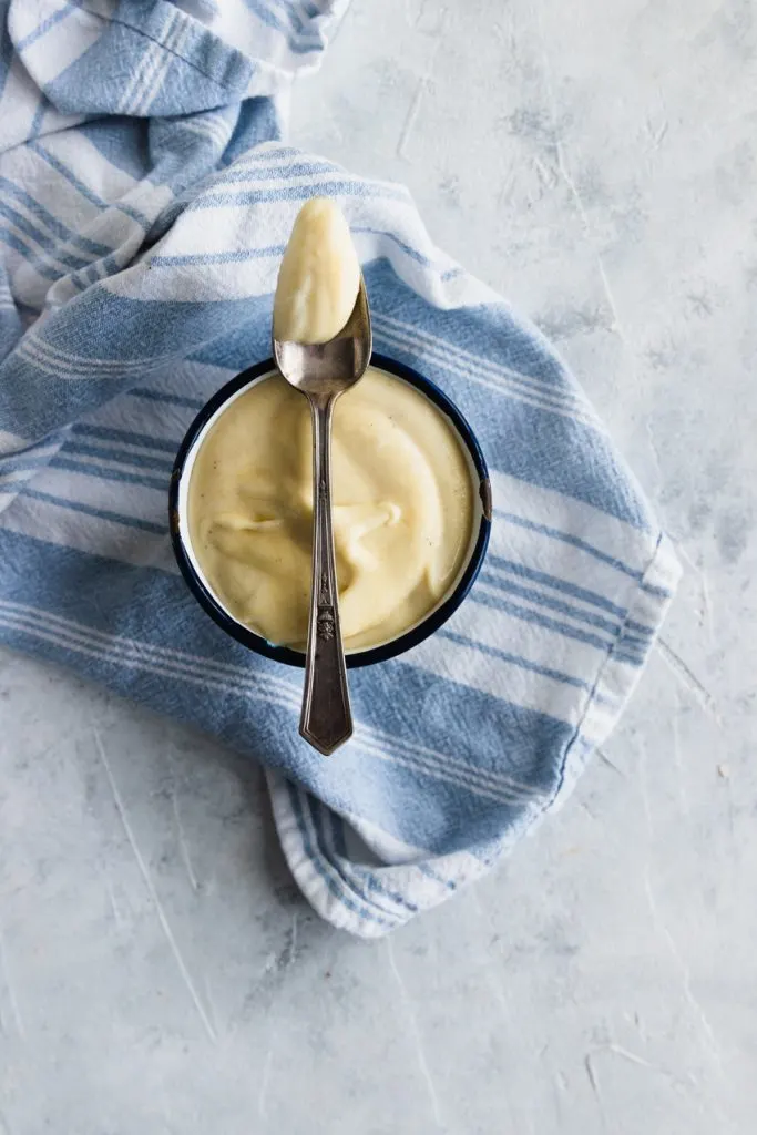 Creamy, thick, classic pastry cream on a spoon.