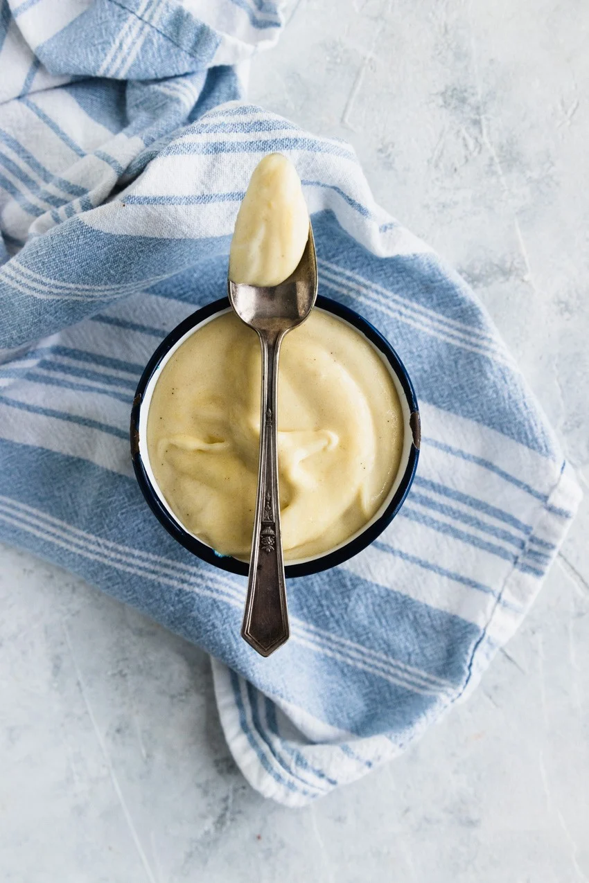 Creamy, thick, classic pastry cream on a spoon.