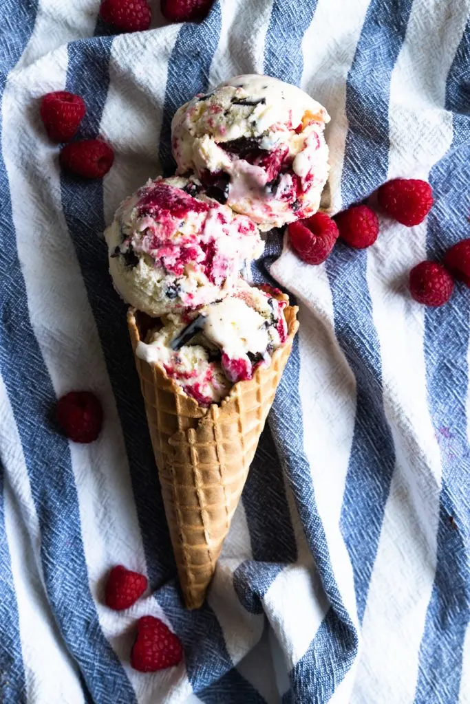 Three scoops of chocolate and raspberry swirl ice cream in a cone