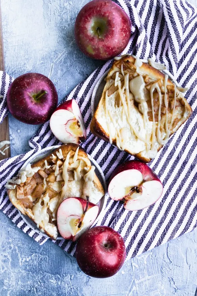 Two slices of apple bread, full of soft, spiced apples and drizzled with brown sugar glaze