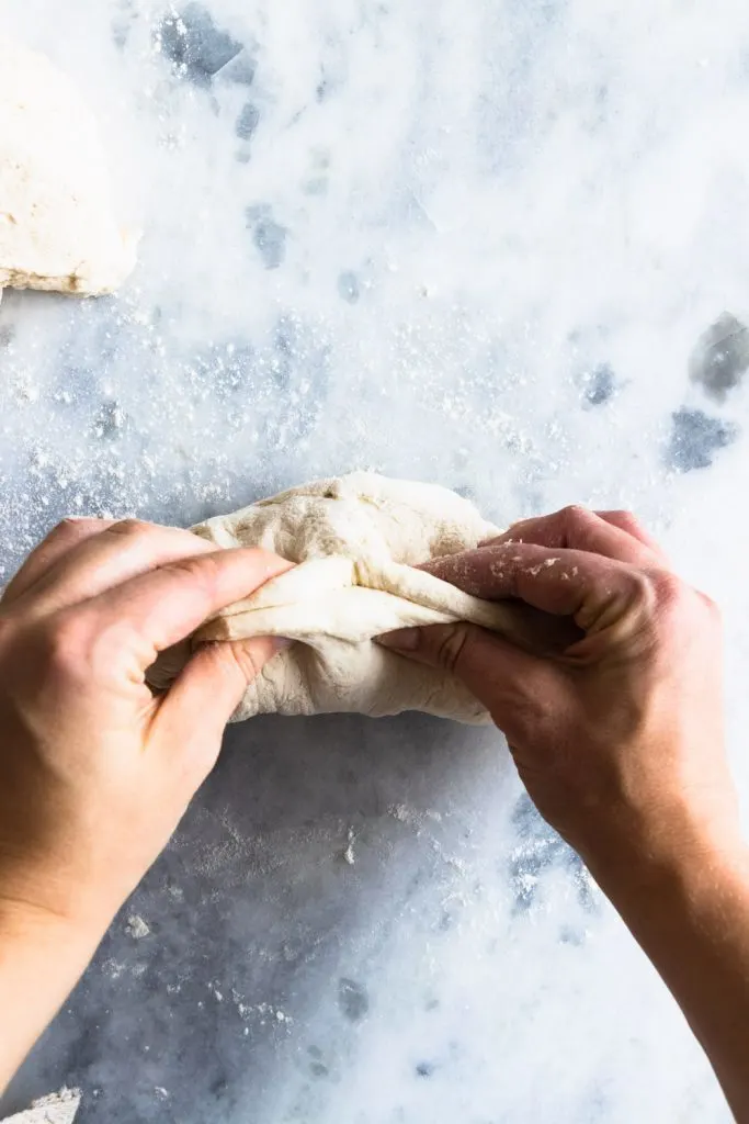 Step two of shaping: Pinch together the edges of the dough.