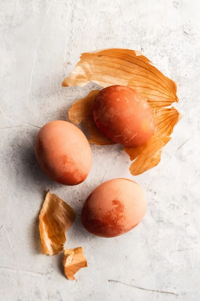 Three orange Easter eggs dyes with yellow onion skins