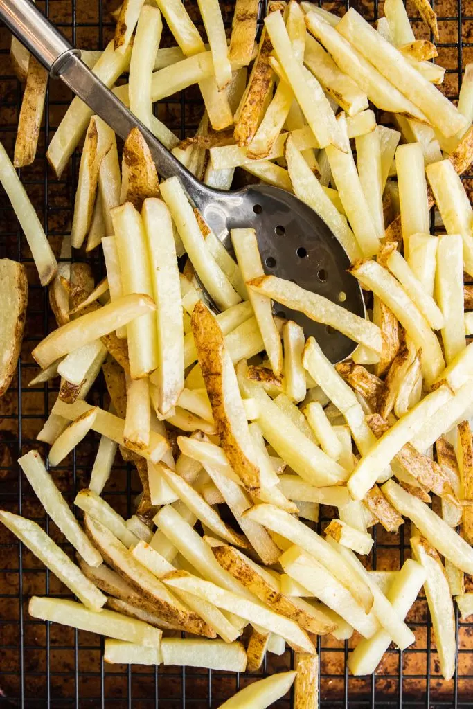 Homemade French Fries after the first fry, ready to be chilled and fried again.