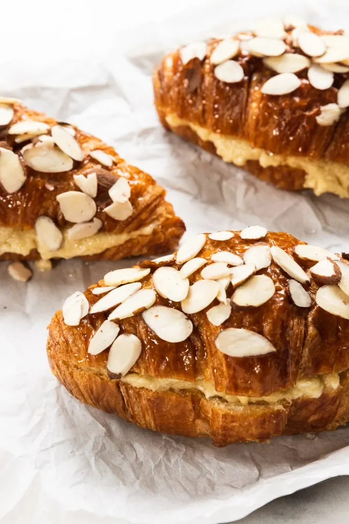 Filled almond croissants, topped with sliced almonds and ready to bake.