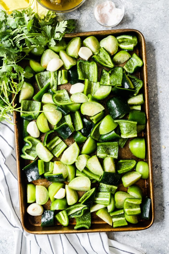 The chopped vegetables on a baking tray, ready to be roasted.