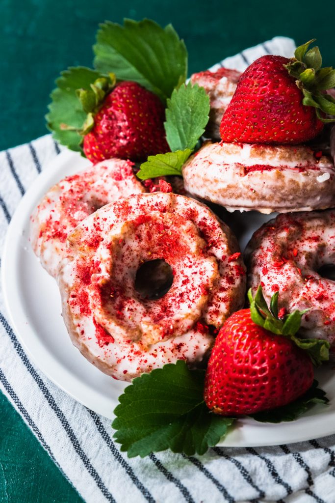 A plate of strawberry donuts