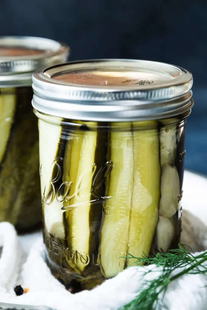 A jar of pickles made with this canned dill pickle recipe for fresh, crisp pickles year round.