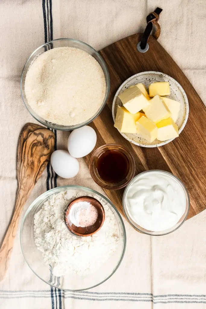The ingredients for coffee cake muffins--butter, sugar, eggs, vanilla & almond extracts, flour, baking powder, and salt.