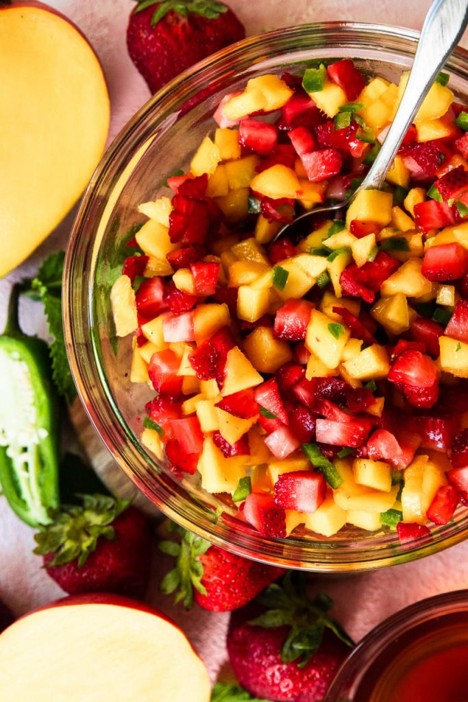 Mix all of the fruit and jalapeno together before adding the dressing.