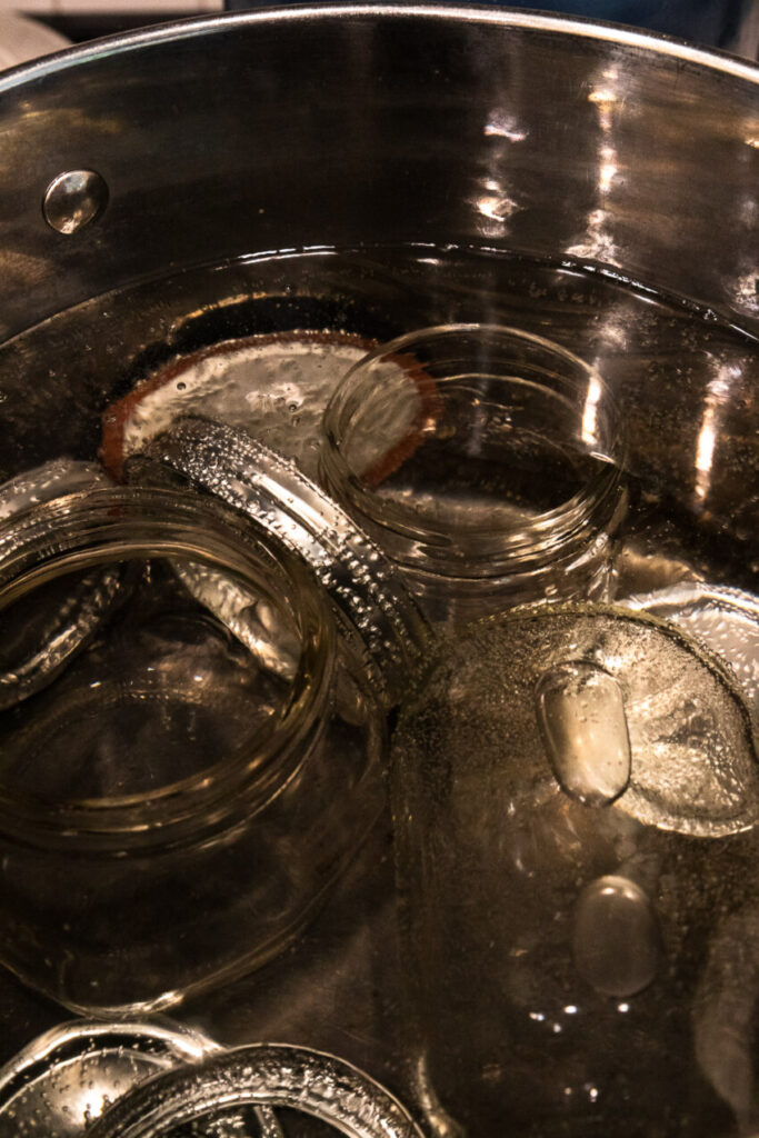 Sterilize the jars before canning with them to increase food safety.