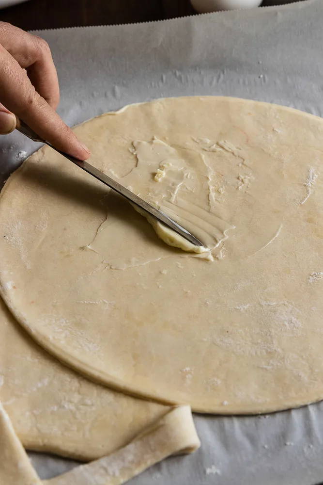 Spread a thin layer of butter over the puff pastry to help the cinnamon sugar stick better. This helps it not fall out when you're twisting the ends of the star.