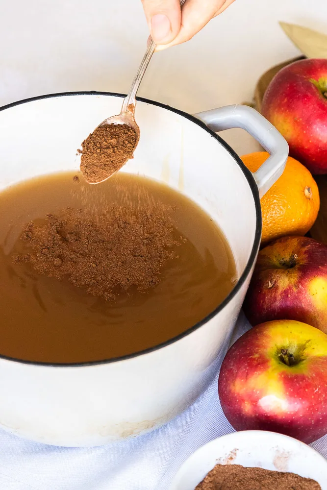 Sprinkling chai spice into the apple cider.